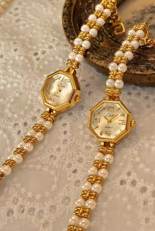 Le Belle Heure women’s gold octagonal quartz watch with pearl and gold bracelet strap on vintage surface