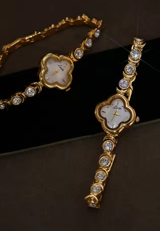 Gold four-leaf clover shaped mother-of-pearl dial quartz watch on a bezel-set round crystal tennis bracelet for women by Le Belle Heure