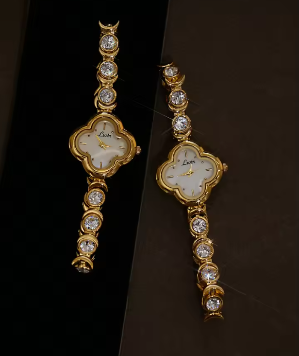 Gold four-leaf clover shaped mother-of-pearl dial quartz watch on a bezel-set round crystal tennis bracelet for women by Le Belle Heure
