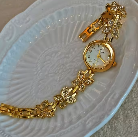 Gold crystal rhinestone butterfly link bracelet watch with mother-of-pearl round dial and Arabic numerals for women by Le Belle Heure