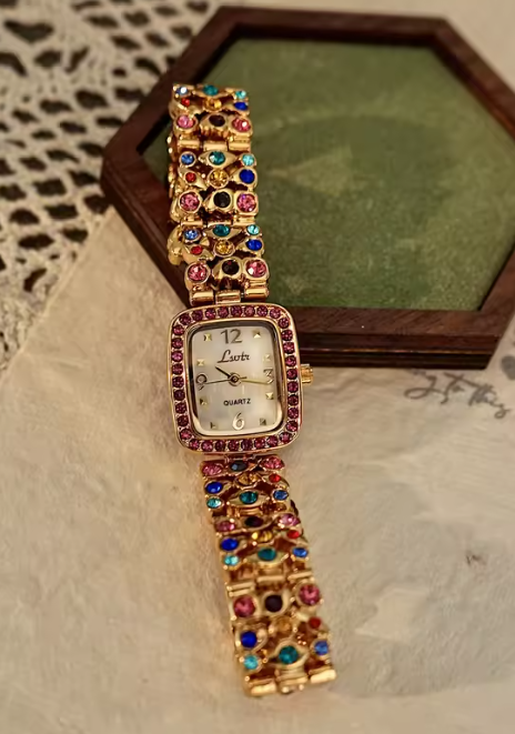 Gold-tone women’s bracelet watch with multicolour rhinestones and pink crystal bezel by Le Belle Heure