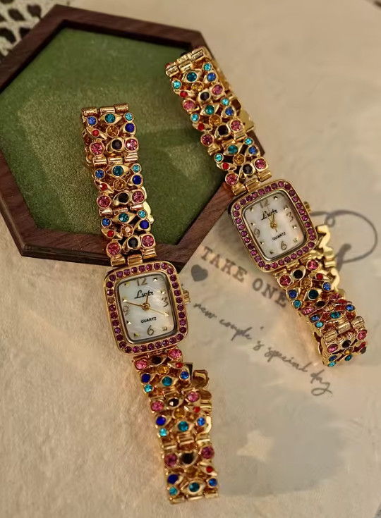 Gold-tone women’s bracelet watch with multicolour rhinestones and pink crystal bezel by Le Belle Heure
