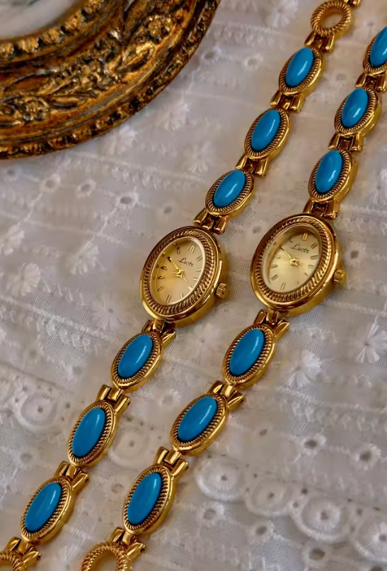 Gold rope-edge bracelet watch with vivid turquoise oval cabochon stone links and champagne oval dial for women by Le Belle Heure