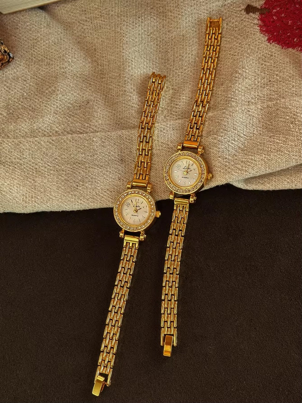 Gold rhinestone halo bezel bracelet watch with white dial and
multi-row panther chain band for women by Le Belle Heure
