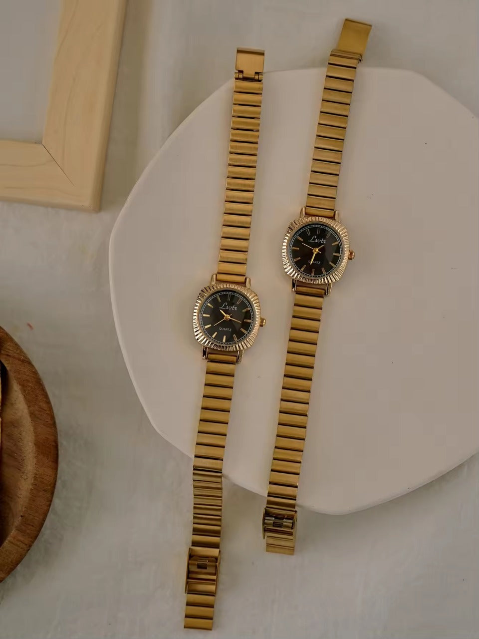 gold ribbed coin-edge bezel flex band watch with black oval dial for women by Le Belle Heure