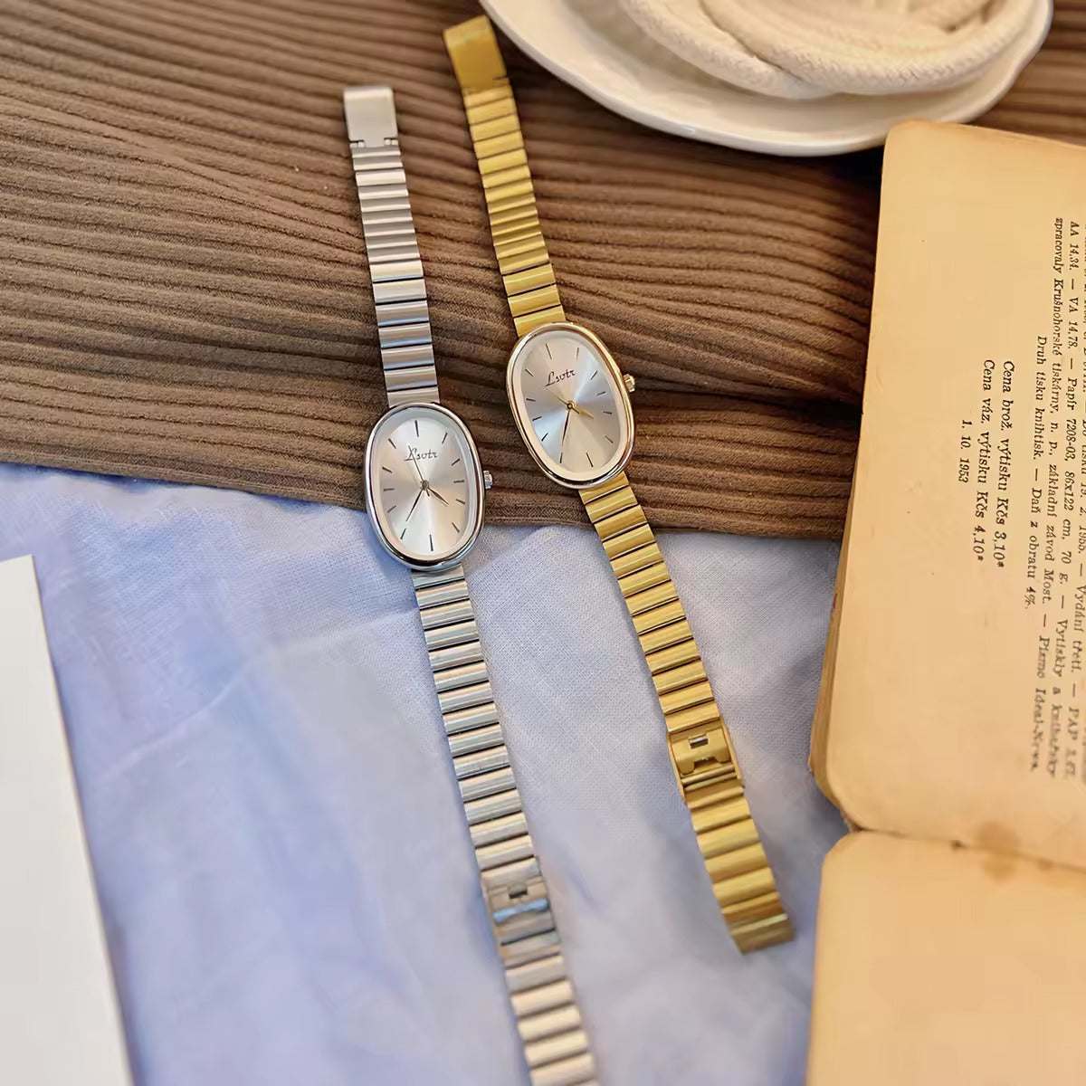 gold minimalist oval dial flex band bracelet watch with sunray silver dial and baton hour markers for women by Le Belle Heure