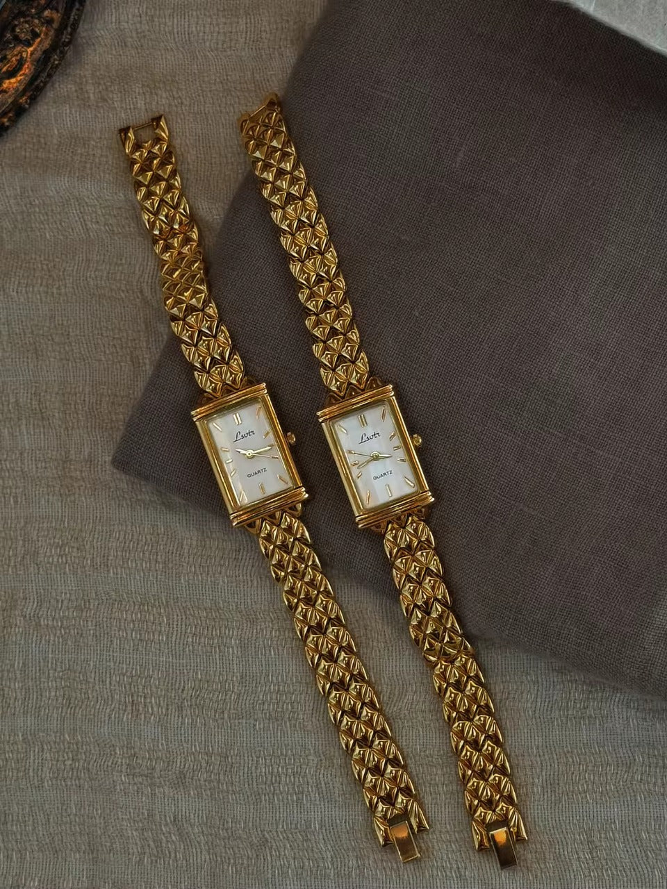 Gold pyramid quilted stud chain wide bracelet watch with white rectangular dial and gold baton hour markers for women by Le Belle Heure