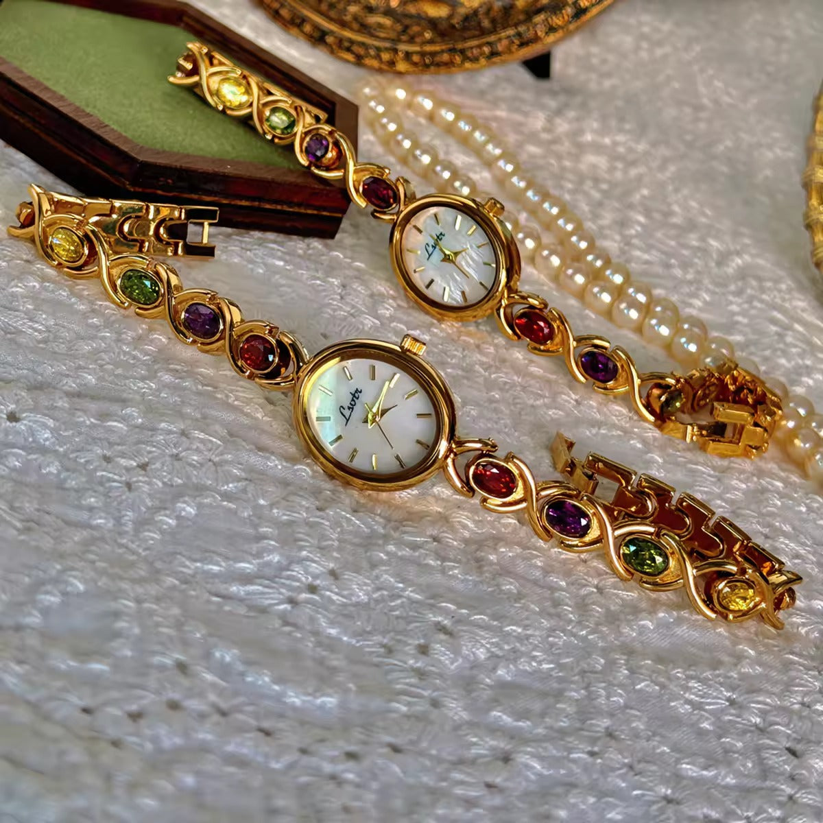 Gold XO link bracelet watch with mother-of-pearl oval dial and multicolour oval gemstones in ruby, amethyst, peridot and citrine for women by Le Belle Heure