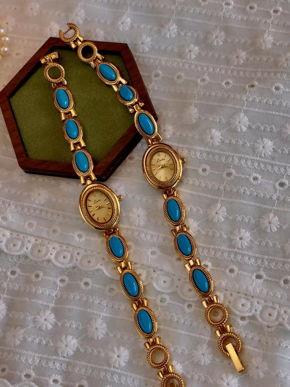 Gold rope-edge bracelet watch with vivid turquoise oval cabochon stone links and champagne oval dial for women by Le Belle Heure