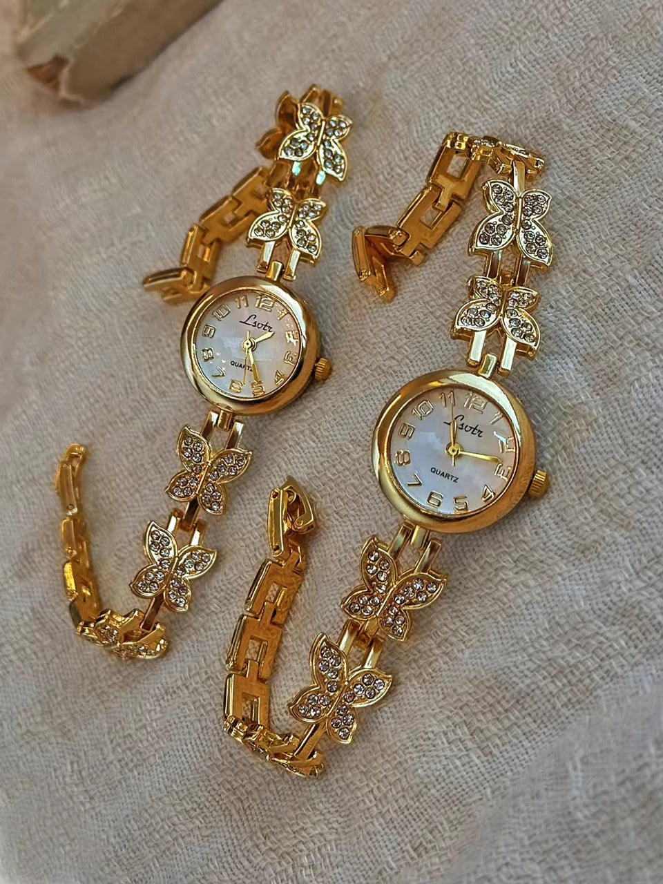 Gold crystal rhinestone butterfly link bracelet watch with mother-of-pearl round dial and Arabic numerals for women by Le Belle Heure