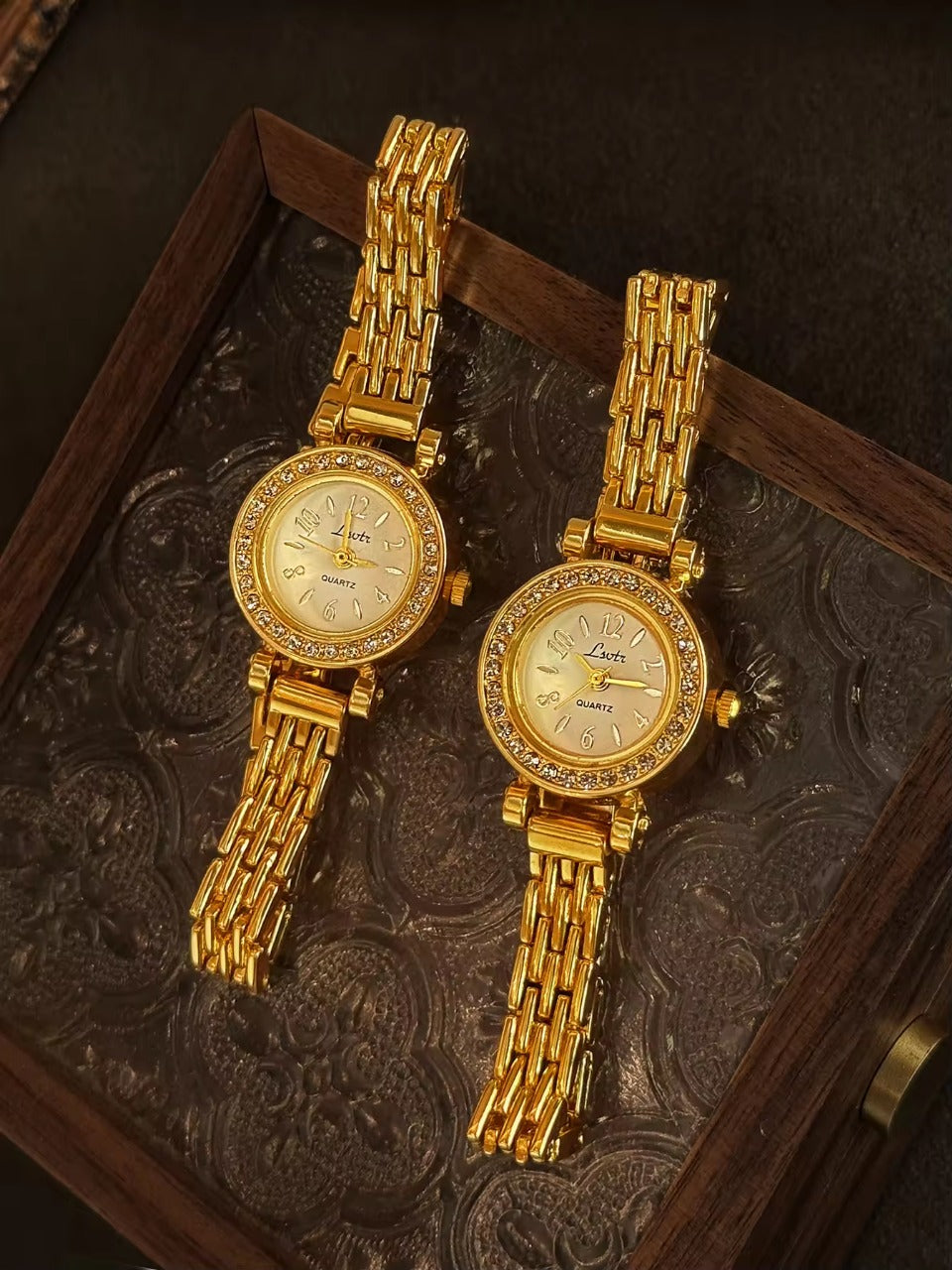 Gold rhinestone halo bezel bracelet watch with white dial and
multi-row panther chain band for women by Le Belle Heure