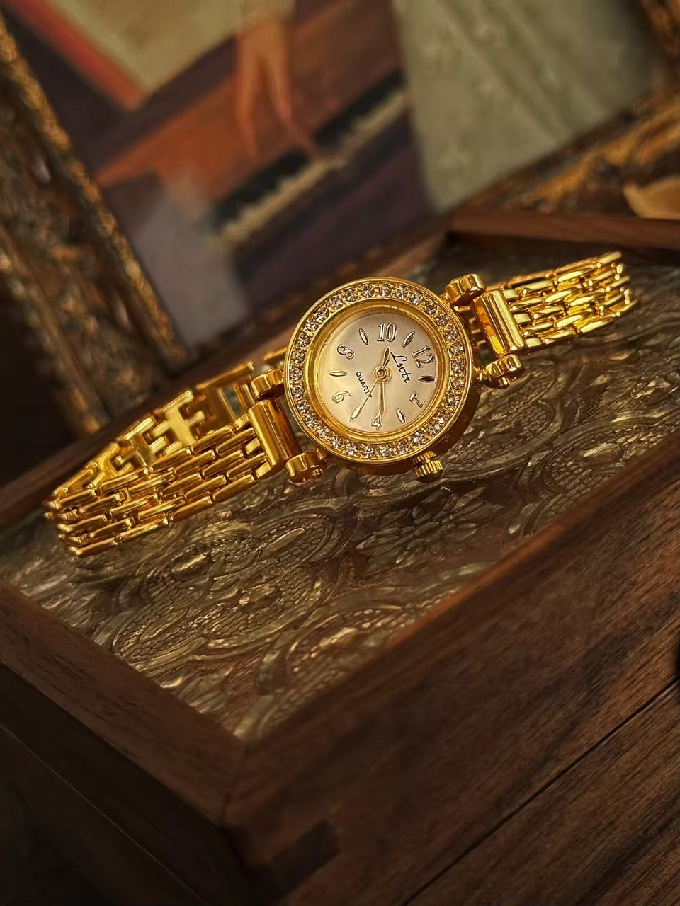 Gold rhinestone halo bezel bracelet watch with white dial and
multi-row panther chain band for women by Le Belle Heure
