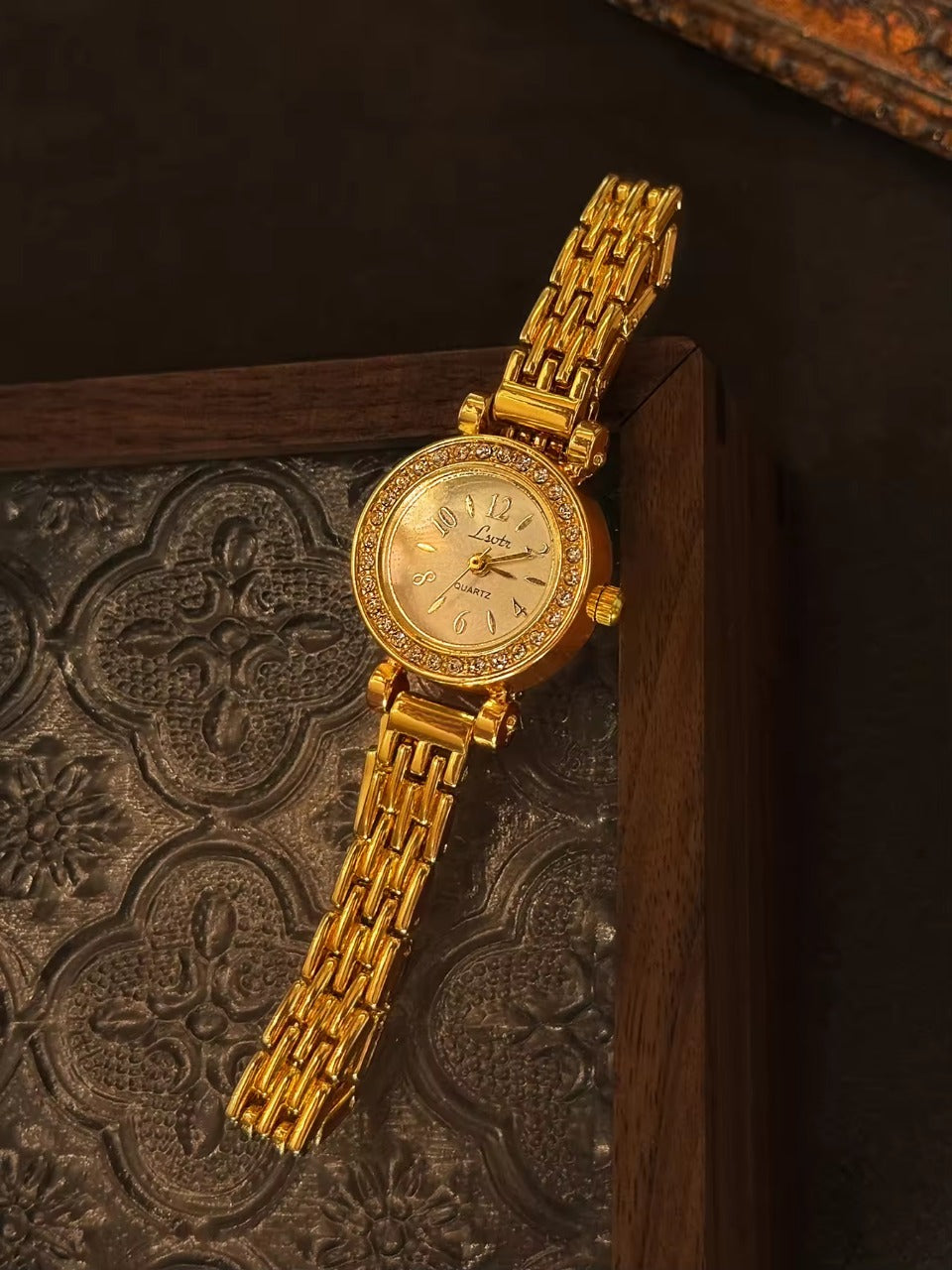 Gold rhinestone halo bezel bracelet watch with white dial and
multi-row panther chain band for women by Le Belle Heure