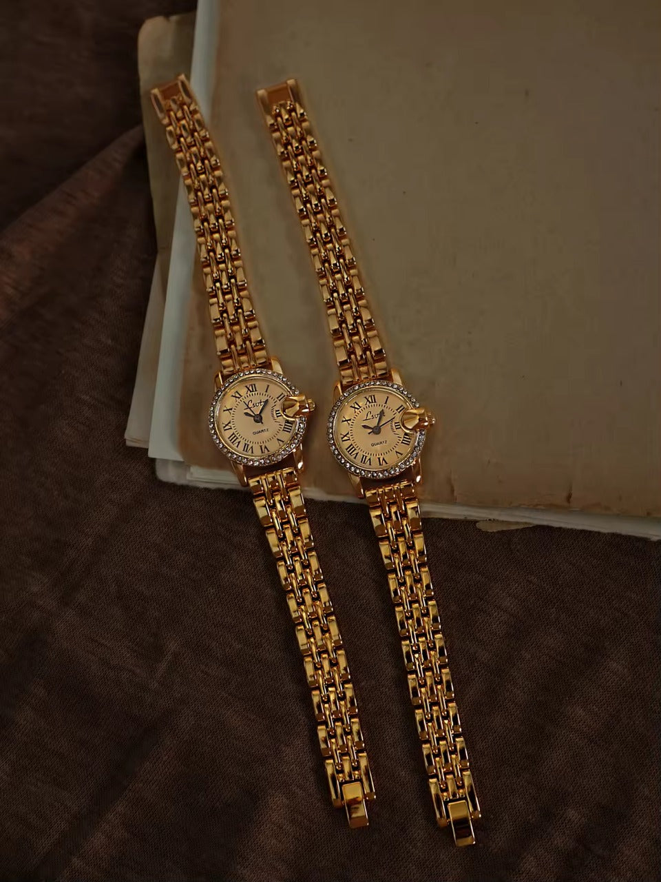 Gold ladies bracelet watch with champagne Roman numeral dial, pav´e
crystal halo bezel and wide multi-row panther chain by Le Belle Heure