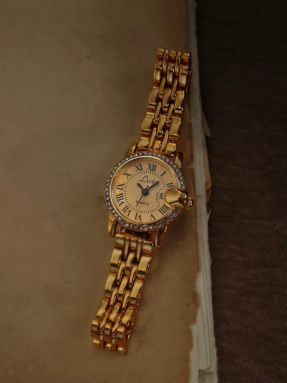 Gold ladies bracelet watch with champagne Roman numeral dial, pave crystal halo bezel and wide multi-row panther chain by Le Belle Heure
