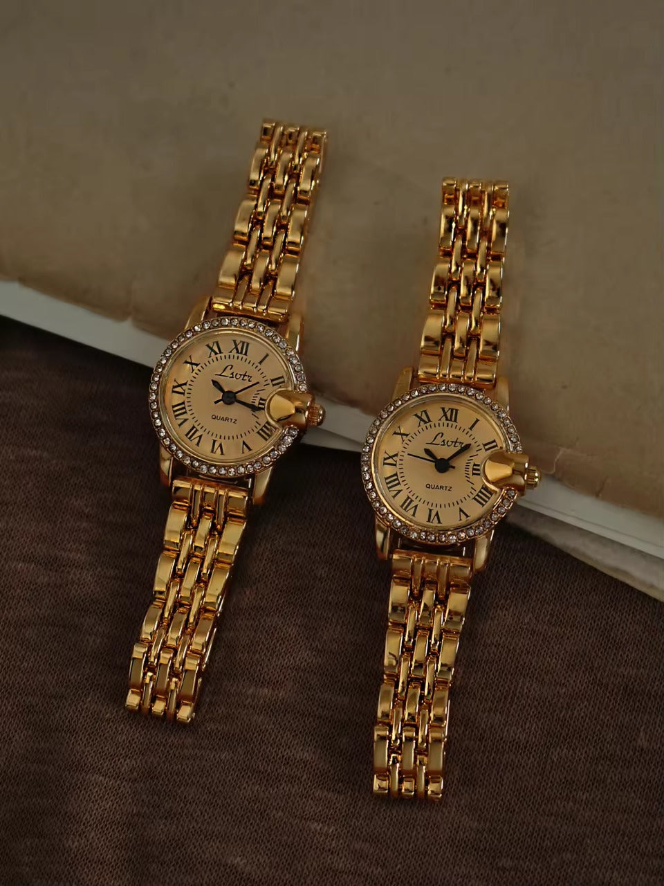 Gold ladies bracelet watch with champagne Roman numeral dial, pav´e
crystal halo bezel and wide multi-row panther chain by Le Belle Heure