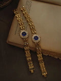 Gold bracelet watch with navy blue dial and baguette crystal starburst
halo bezel on wide panther chain band for women by Le Belle Heure