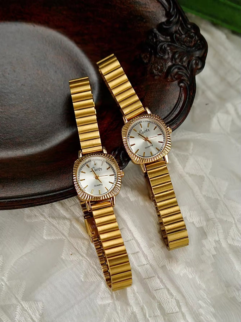 gold ribbed coin-edge bezel flex band watch with white oval dial for women by Le Belle Heure