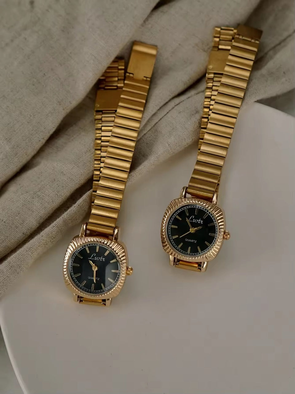gold ribbed coin-edge bezel flex band watch with black oval dial for women by Le Belle Heure