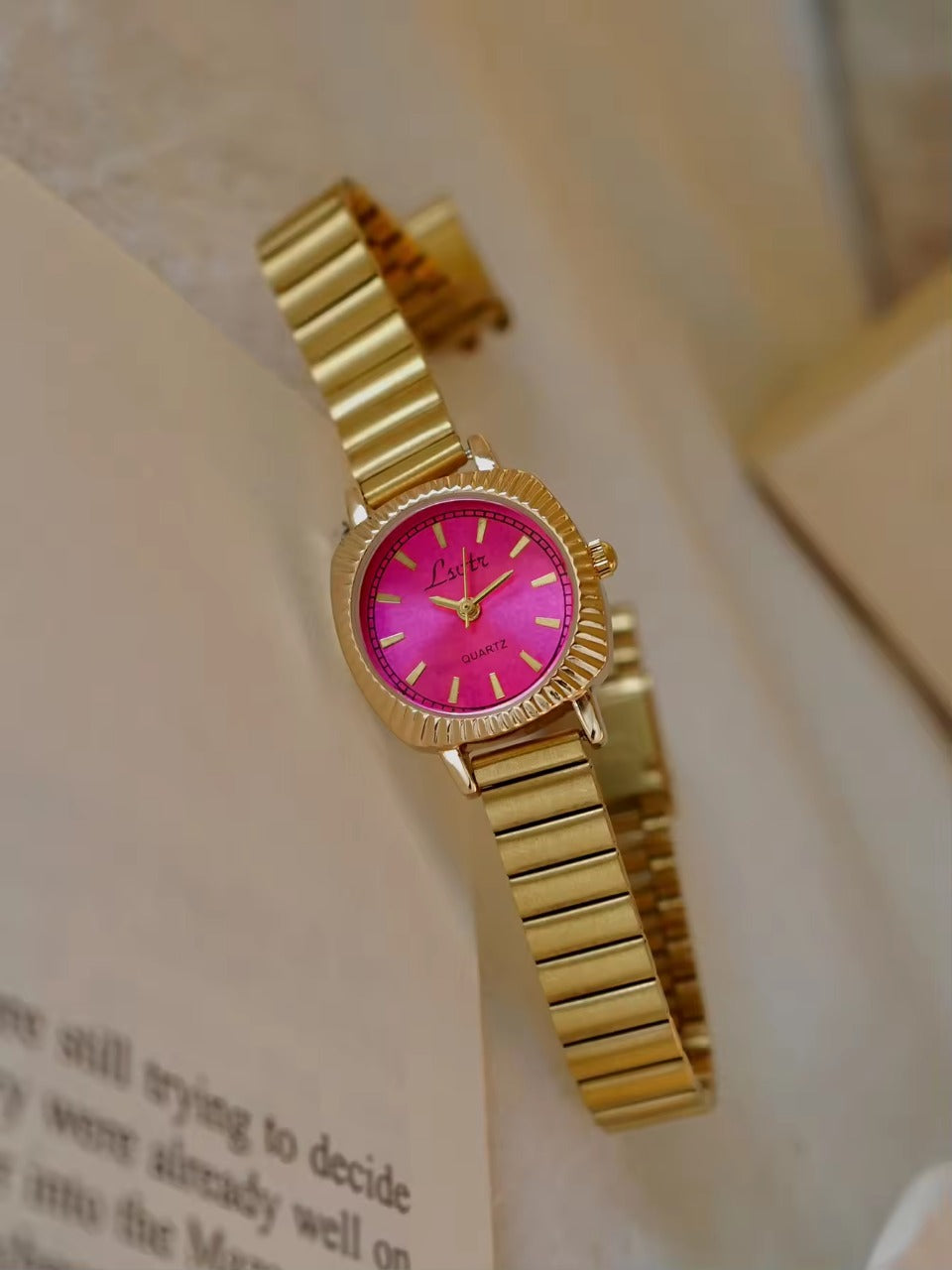 gold ribbed coin-edge bezel flex band watch with pink oval dial for women by Le Belle Heure