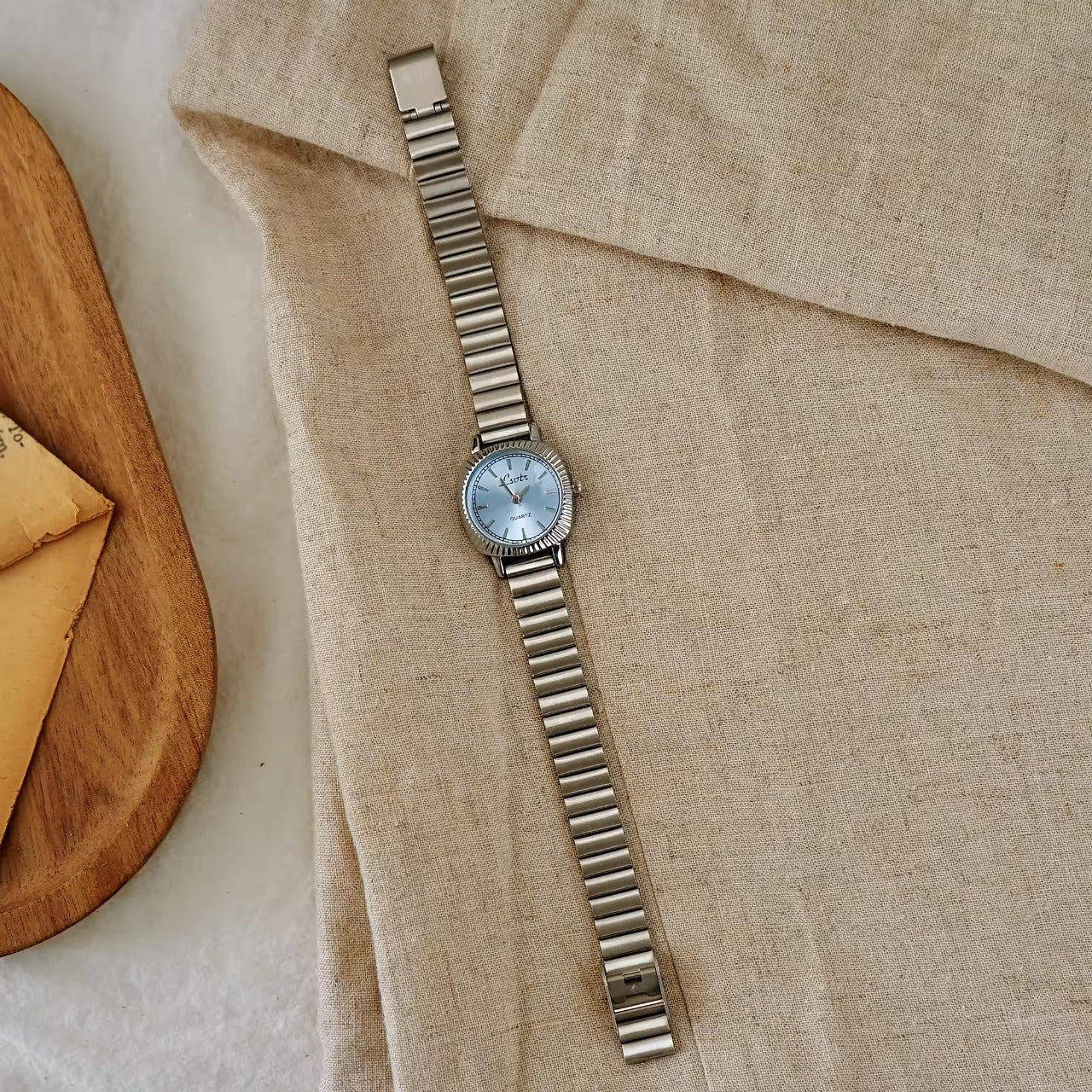 gold ribbed coin-edge bezel flex band watch with blue oval dial for women by Le Belle Heure