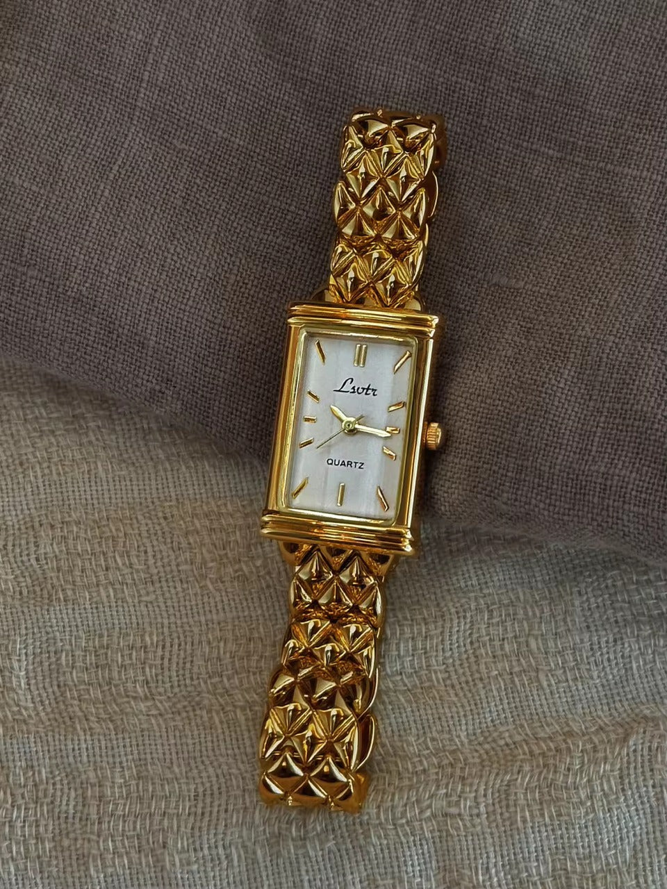 Gold pyramid quilted stud chain wide bracelet watch with white rectangular dial and gold baton hour markers for women by Le Belle Heure