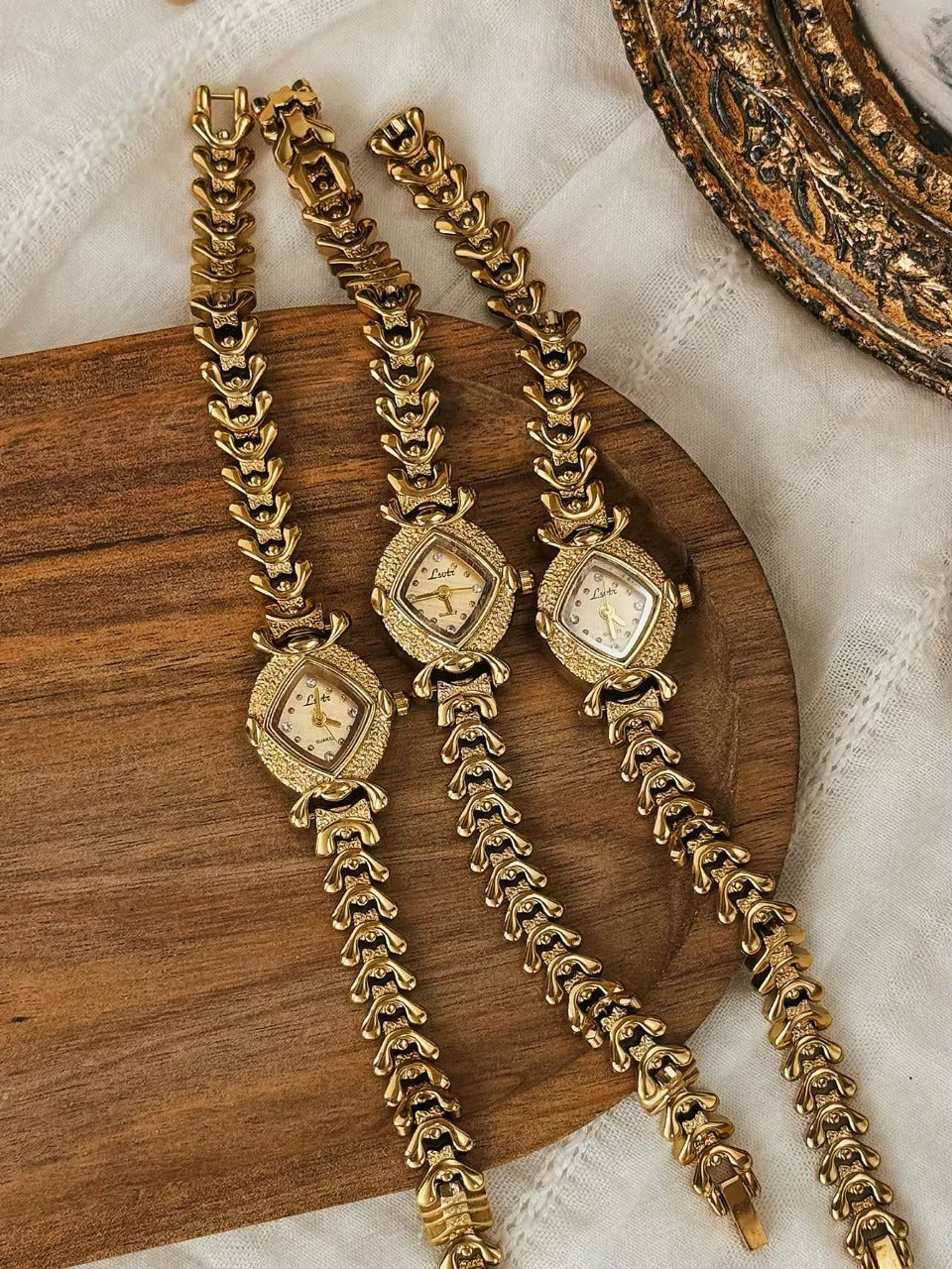 Gold hammered textured cushion square dial ladies bracelet watch
with wheat spine chain and diamond hour markers by Le Belle Heure