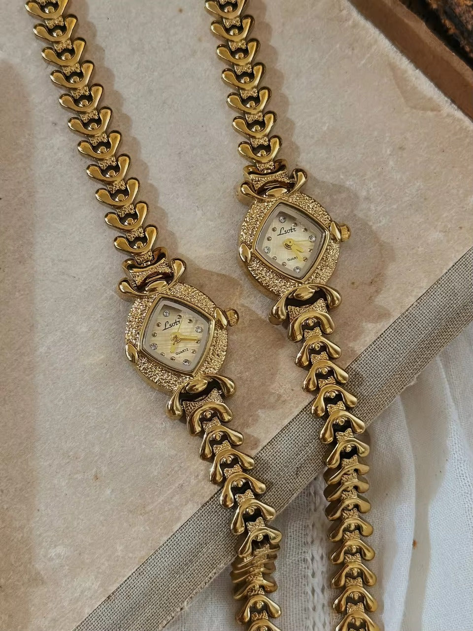 Gold hammered textured cushion square dial ladies bracelet watch
with wheat spine chain and diamond hour markers by Le Belle Heure
