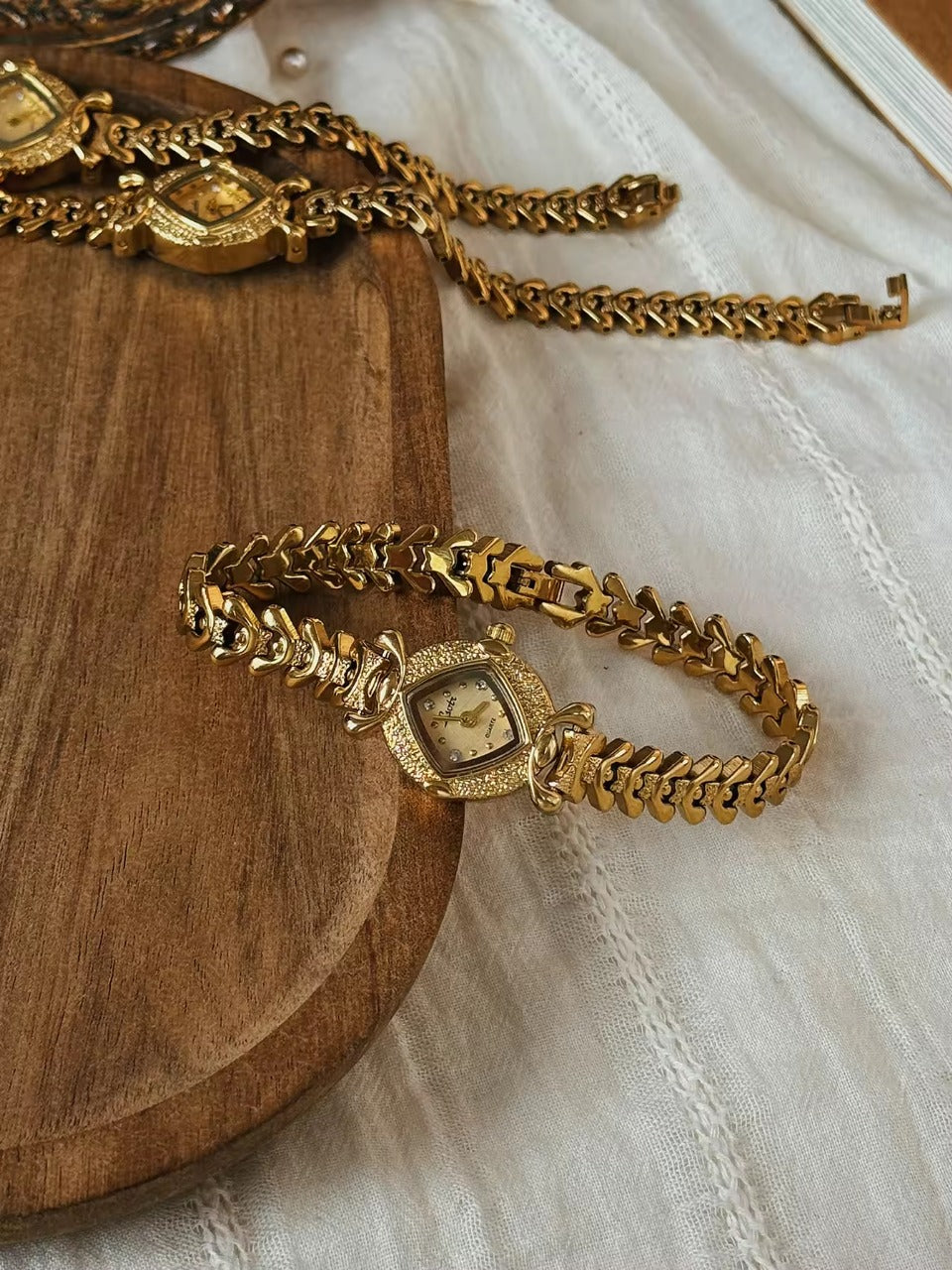 Gold hammered textured cushion square dial ladies bracelet watch
with wheat spine chain and diamond hour markers by Le Belle Heure