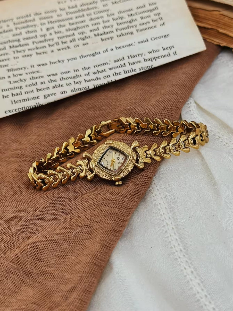 Gold hammered textured cushion square dial ladies bracelet watch
with wheat spine chain and diamond hour markers by Le Belle Heure