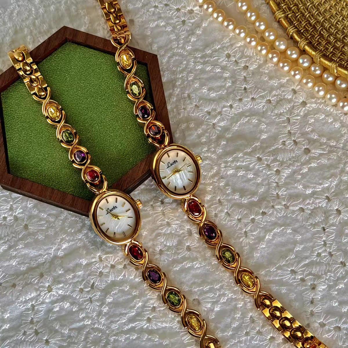 Gold XO link bracelet watch with mother-of-pearl oval dial and multicolour oval gemstones in ruby, amethyst, peridot and citrine for women by Le Belle Heure