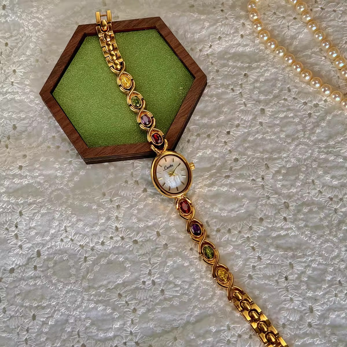 Gold XO link bracelet watch with mother-of-pearl oval dial and multicolour oval gemstones in ruby, amethyst, peridot and citrine for women by Le Belle Heure
