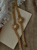Bold gold-tone panther chain link bracelet band on women’s vintage-style flower watch