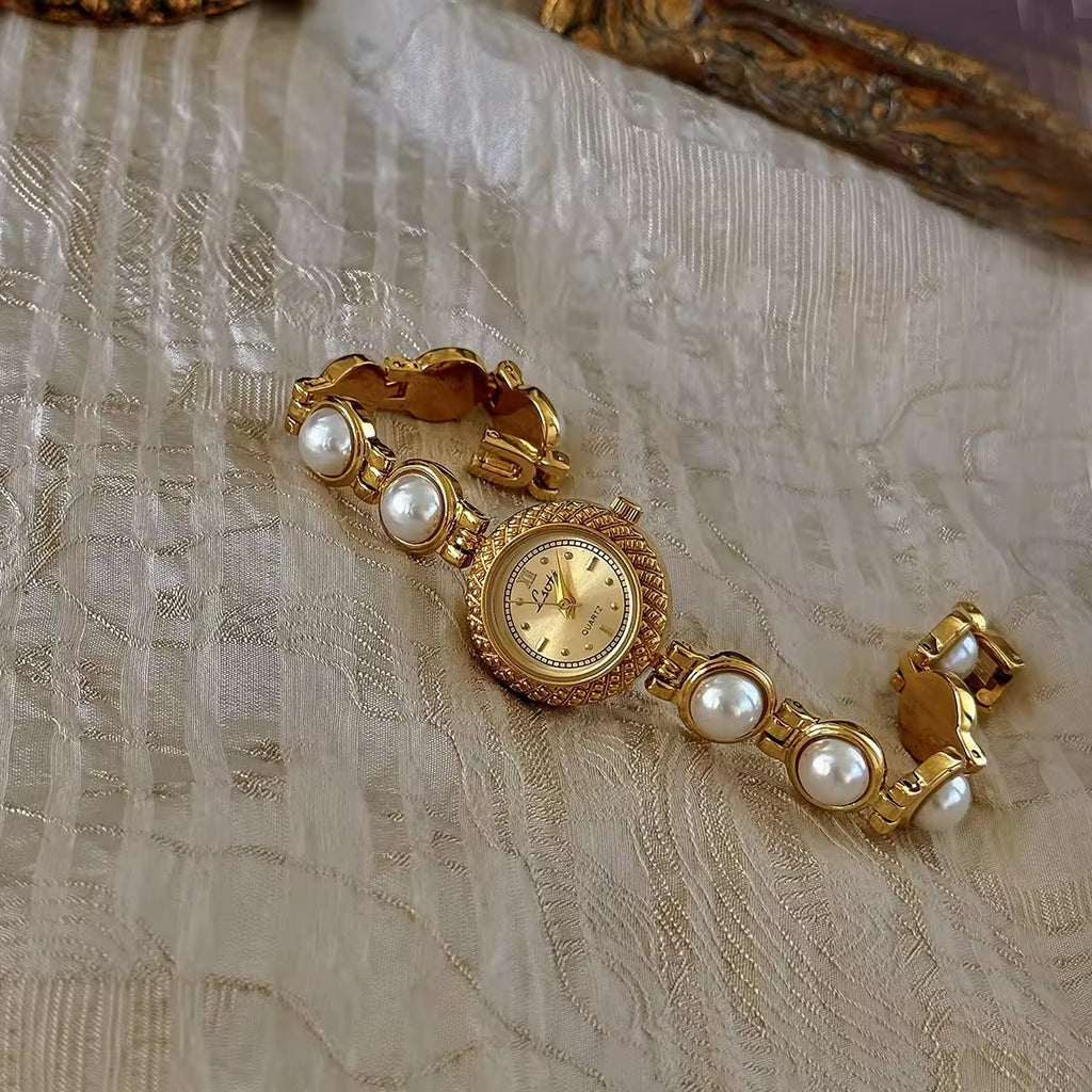 Gold pearl bracelet watch styled on antique gold frame tray – Le Belle Heure women’s watch