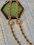 Gold-tone bracelet watch band with ruby-red oval crystals surrounded by white crystal links