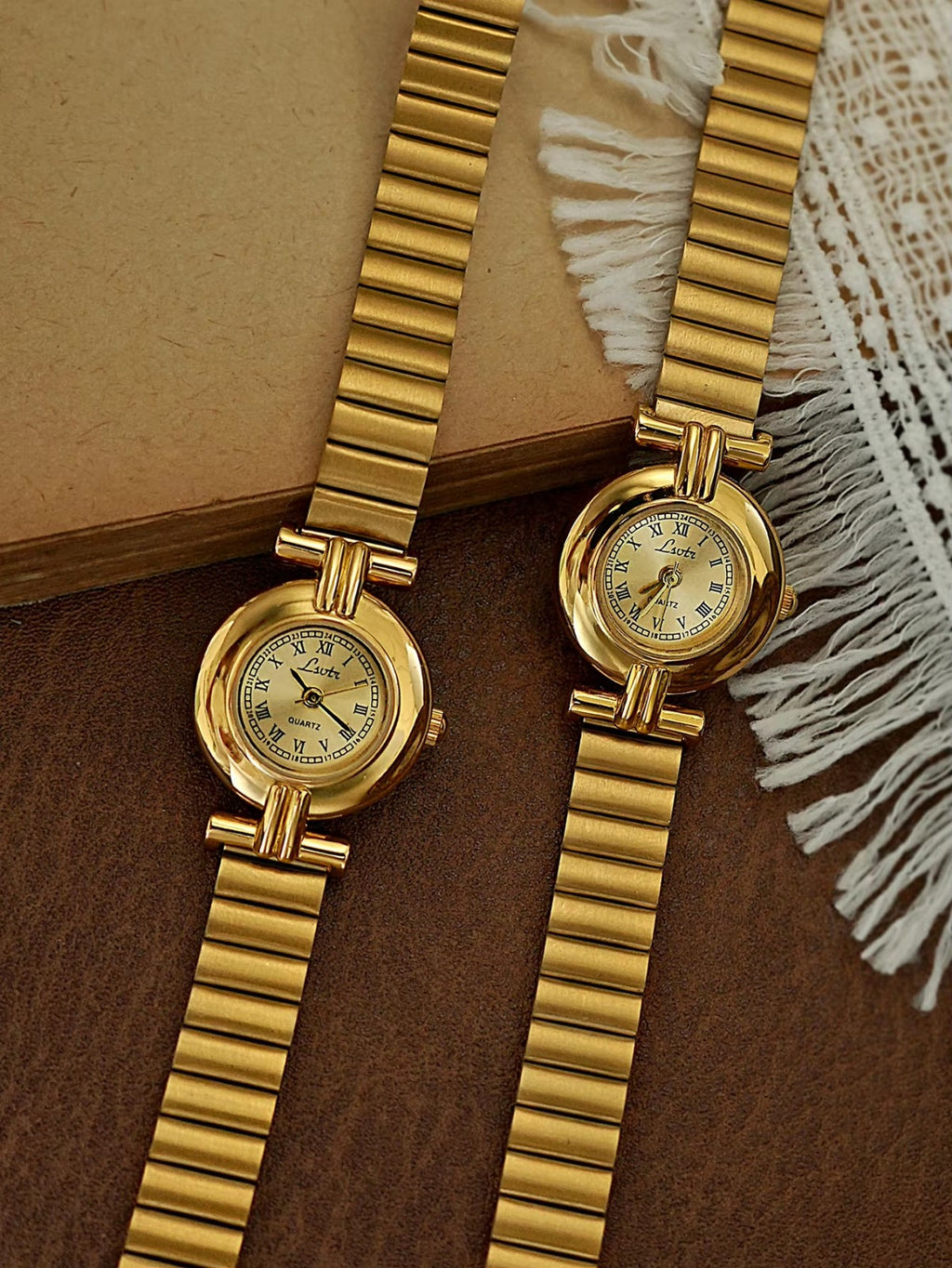 Gold domed oval watch with Roman numeral champagne dial, double
bar lug case connectors and wide ribbed accordion flex band for women by Le Belle Heure
