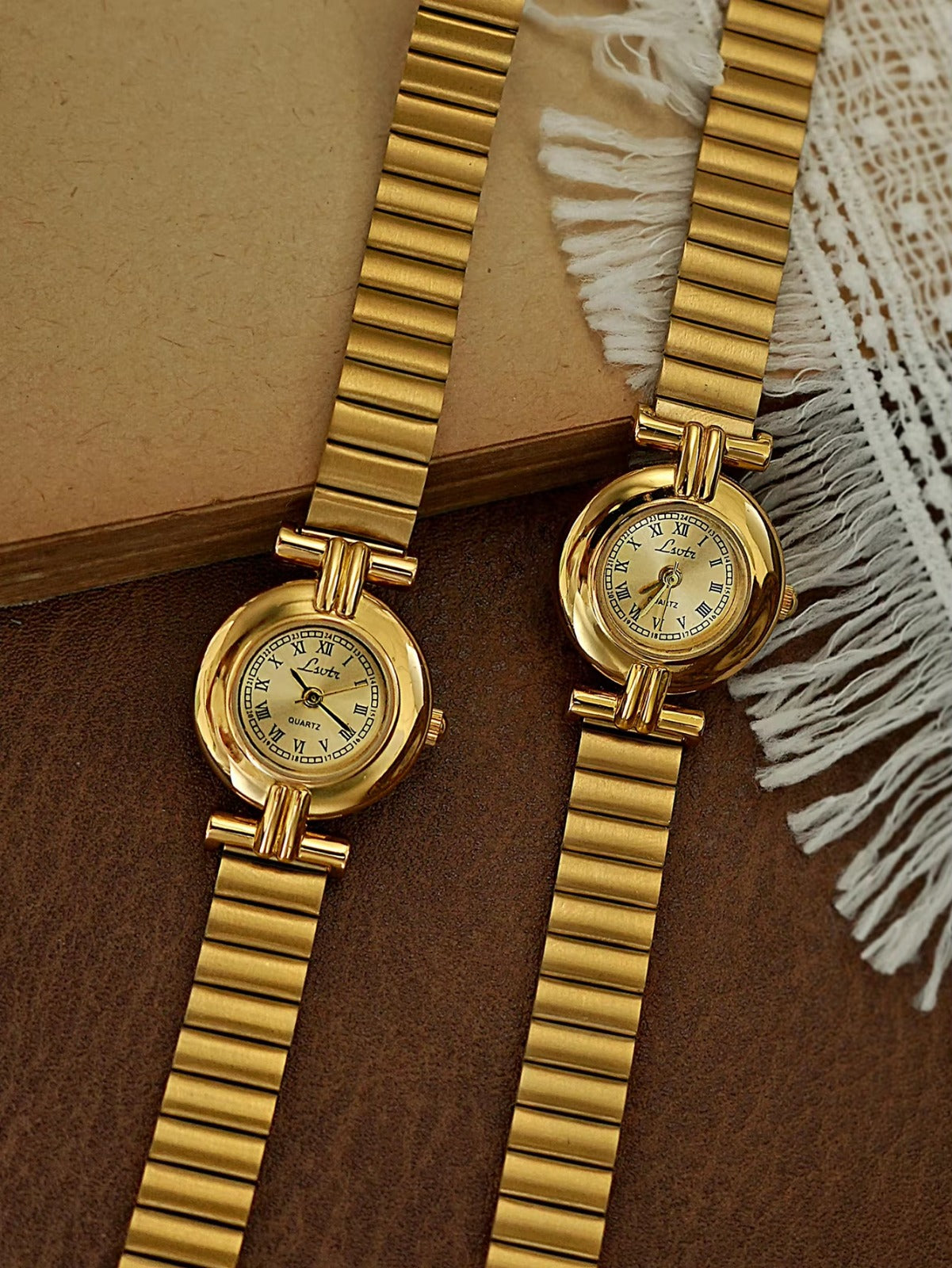 Gold domed oval watch with Roman numeral champagne dial, double
bar lug case connectors and wide ribbed accordion flex band for women by Le Belle Heure
