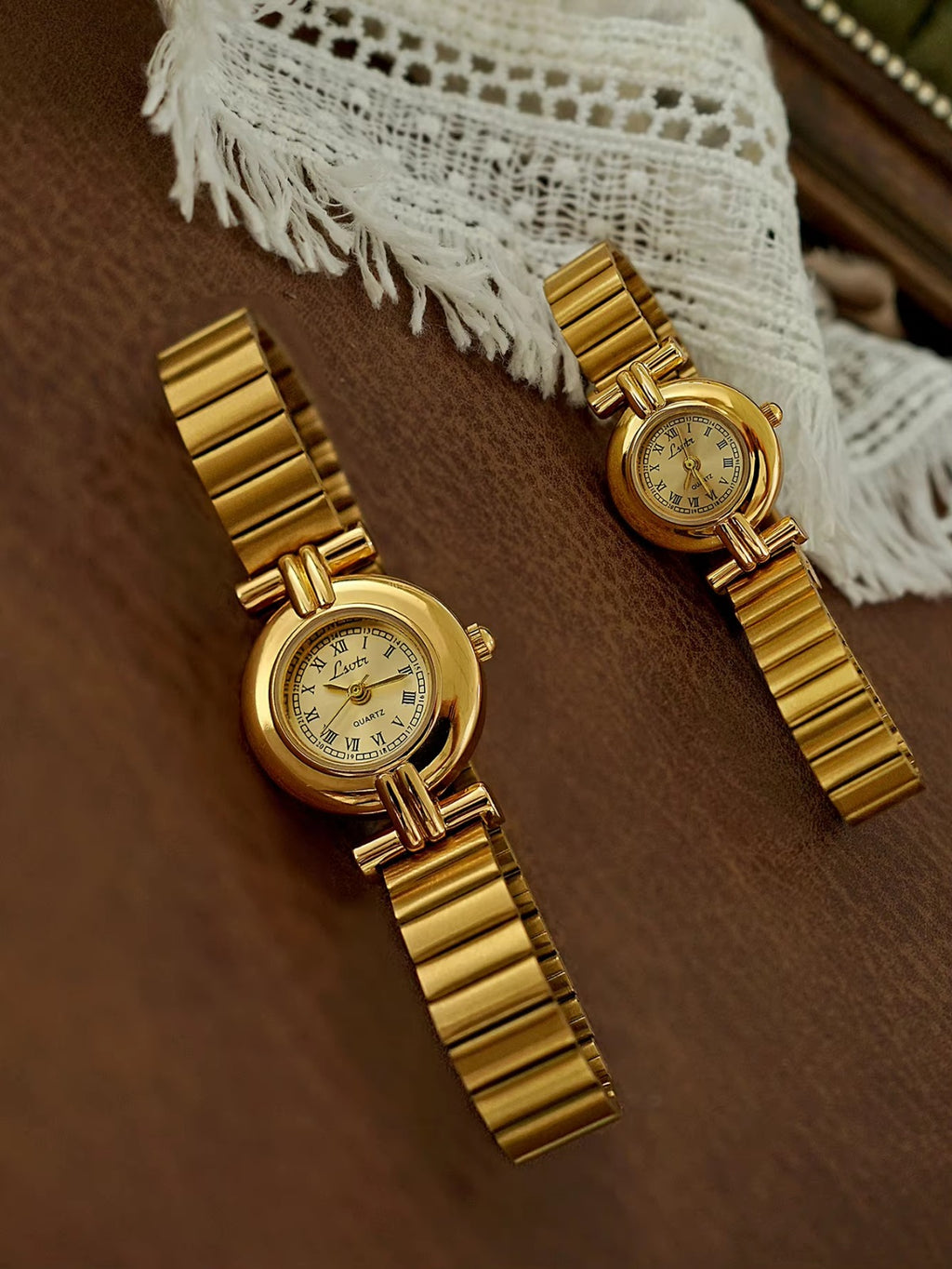 Gold domed oval watch with Roman numeral champagne dial, double
bar lug case connectors and wide ribbed accordion flex band for women by Le Belle Heure