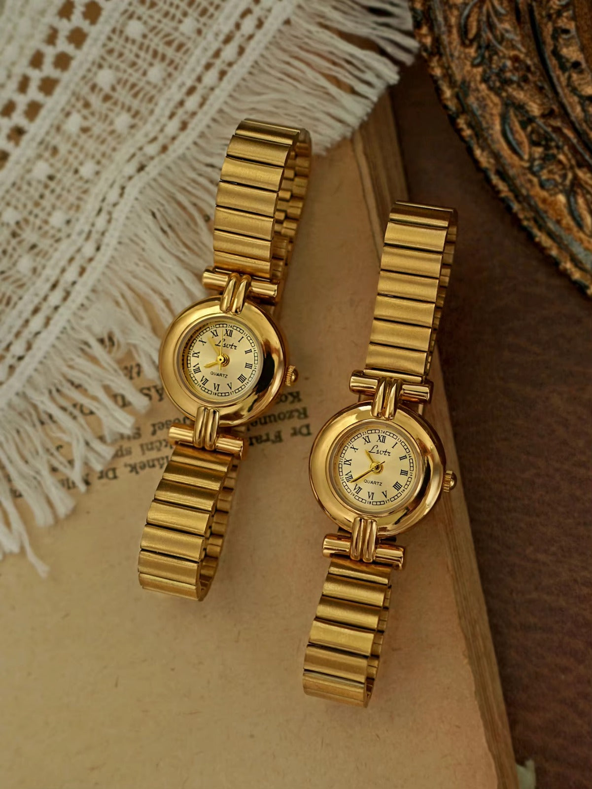 Gold domed oval watch with Roman numeral champagne dial, double
bar lug case connectors and wide ribbed accordion flex band for women by Le Belle Heure