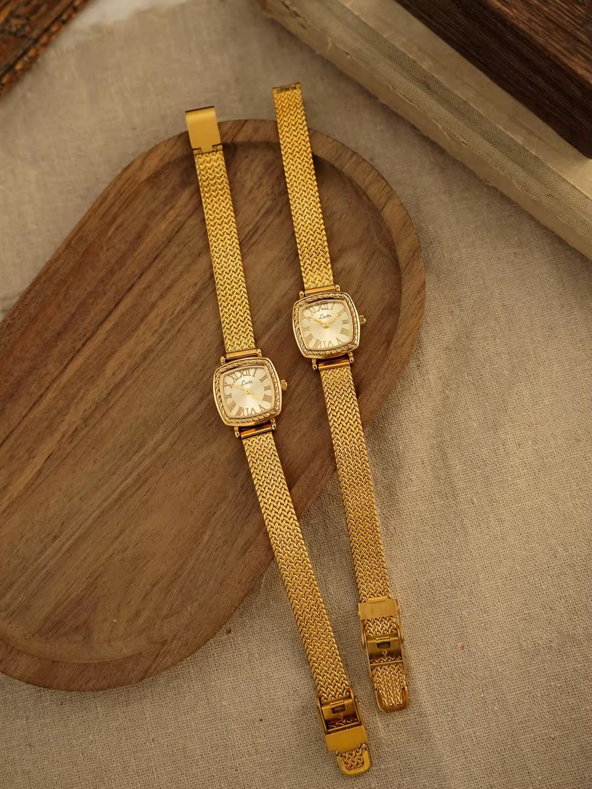 Gold tonneau cushion-shaped watch with engraved rope-twist bezel,
Roman numeral champagne sunburst dial and wide braided herringbone mesh bracelet for women by Le Belle Heure