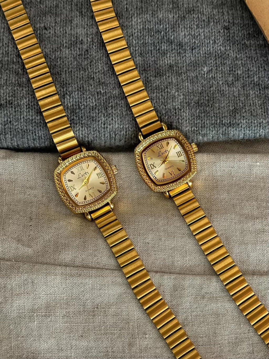 Gold cushion square watch with deeply engraved geometric chevron
bezel, Roman numeral and baton marker champagne dial and structured gold expansion flex bracelet for women by Le Belle Heure