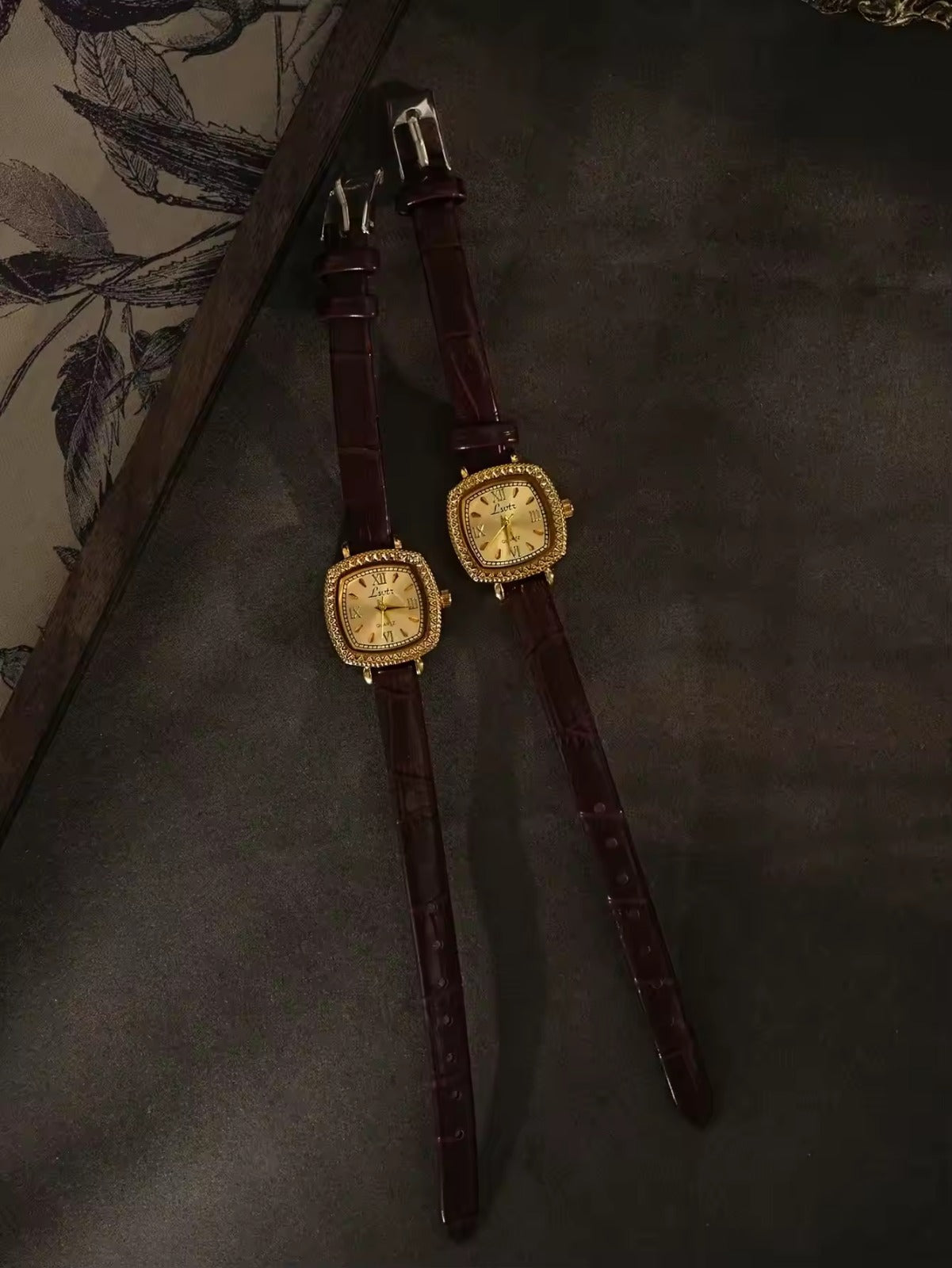 Gold cushion square watch with rope-twist crystal bezel, sunburst
Roman numeral champagne dial and slim dark chocolate crocodile texture leather strap for women by Le Belle Heure