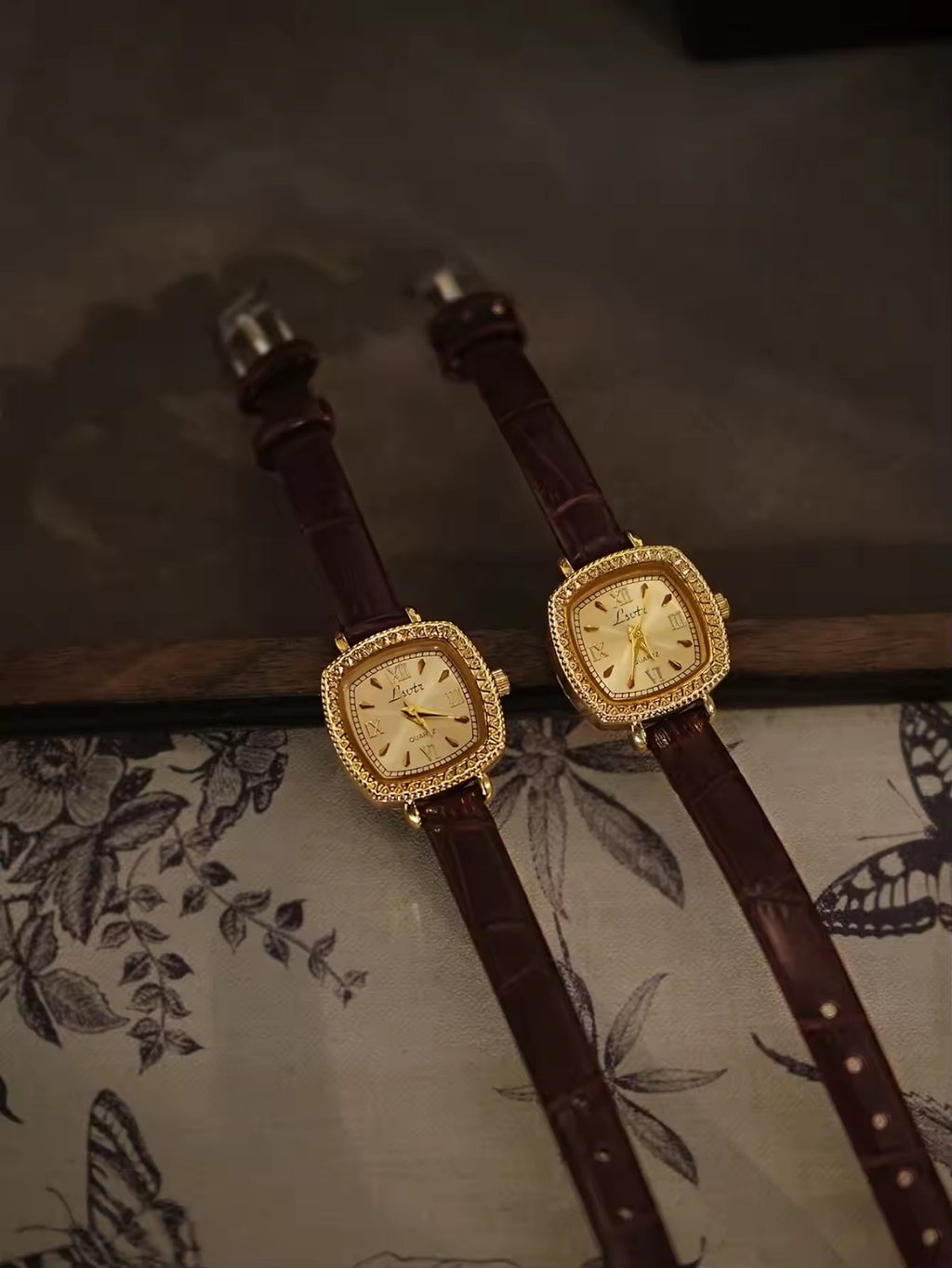 Gold cushion square watch with rope-twist crystal bezel, sunburst
Roman numeral champagne dial and slim dark chocolate crocodile texture leather strap for women by Le Belle Heure