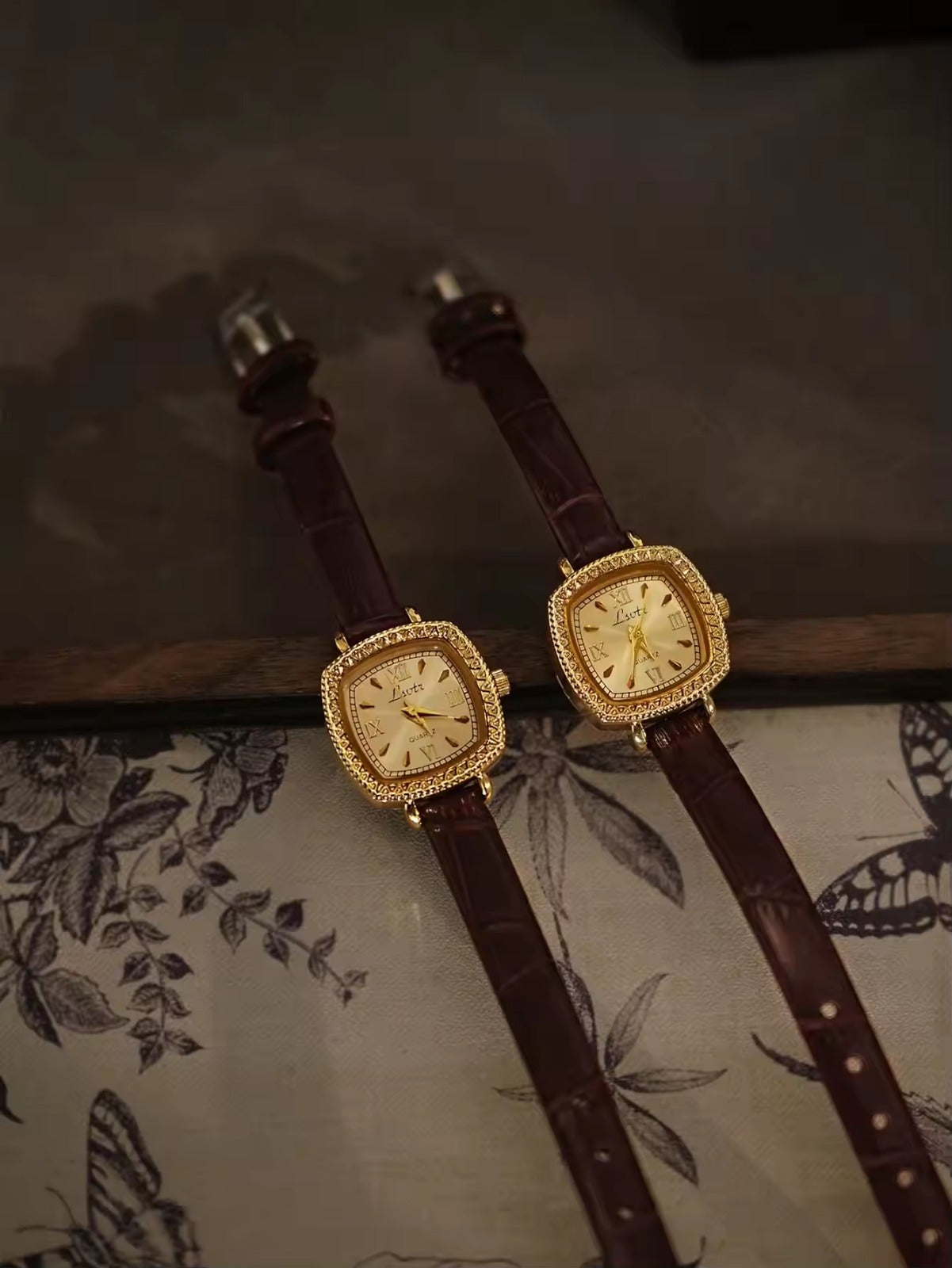 Gold cushion square watch with rope-twist crystal bezel, sunburst
Roman numeral champagne dial and slim dark chocolate crocodile texture leather strap for women by Le Belle Heure