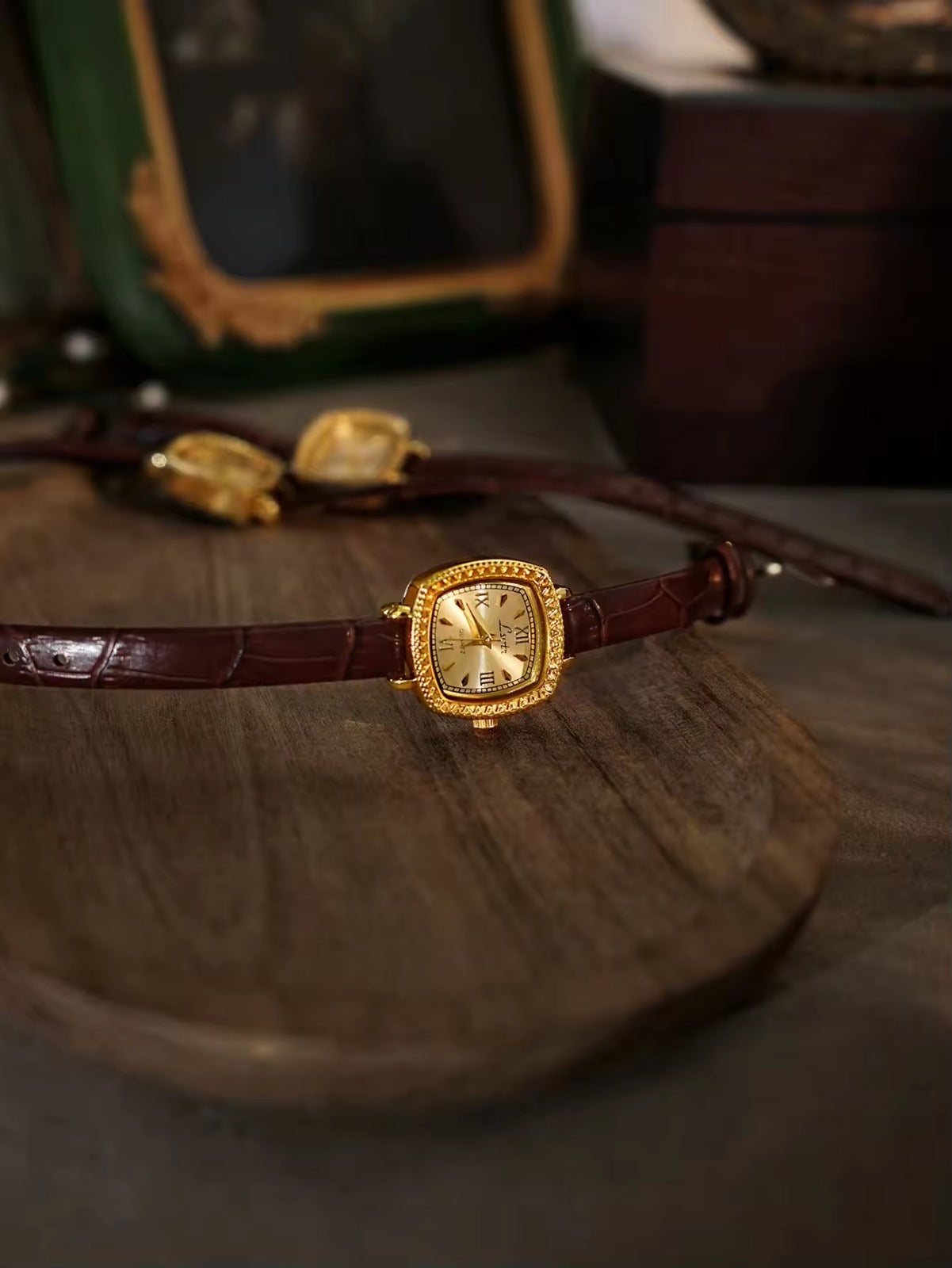 Gold cushion square watch with rope-twist crystal bezel, sunburst
Roman numeral champagne dial and slim dark chocolate crocodile texture leather strap for women by Le Belle Heure