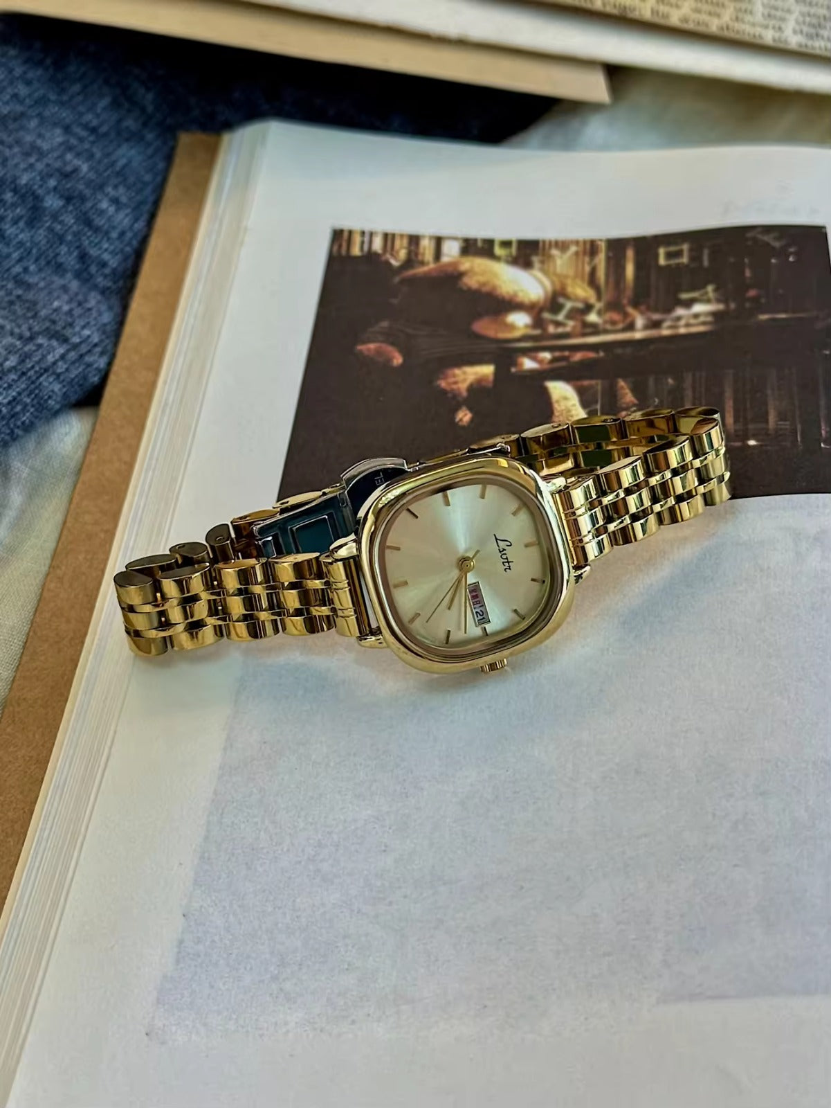 Gold square couple watch set with champagne dial and day-date display on gold stainless steel bracelet - Le Belle Heure