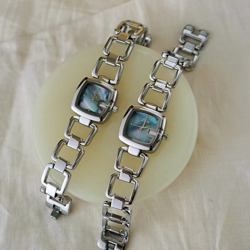 Women’s silver cushion square watch with black mother of pearl dial and open
square-link bracelet — Le Belle Heure