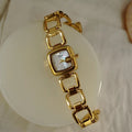 Women’s silver cushion square watch with black mother of pearl dial and open
square-link bracelet — Le Belle Heure
