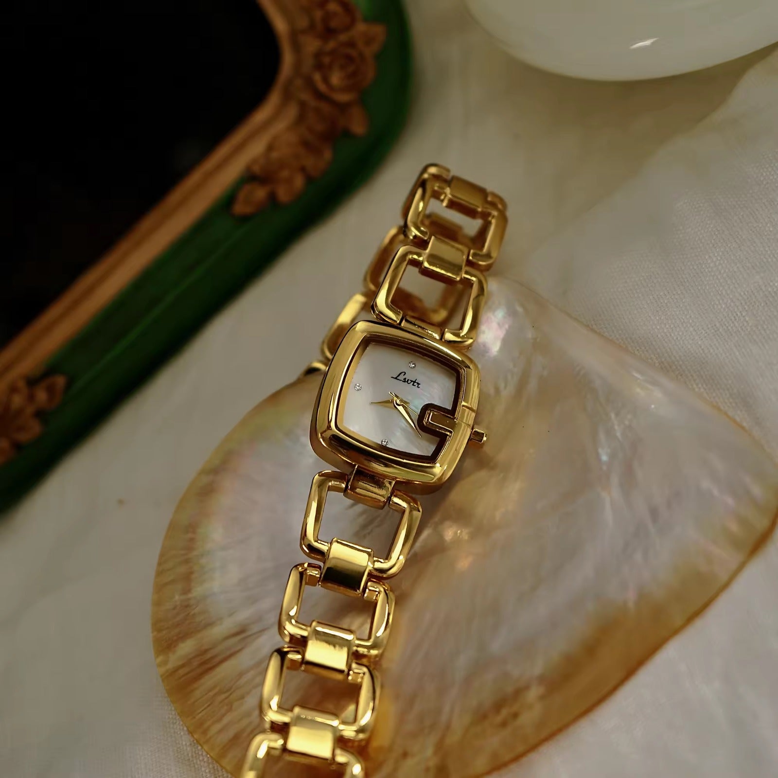 Women’s silver cushion square watch with black mother of pearl dial and open
square-link bracelet — Le Belle Heure