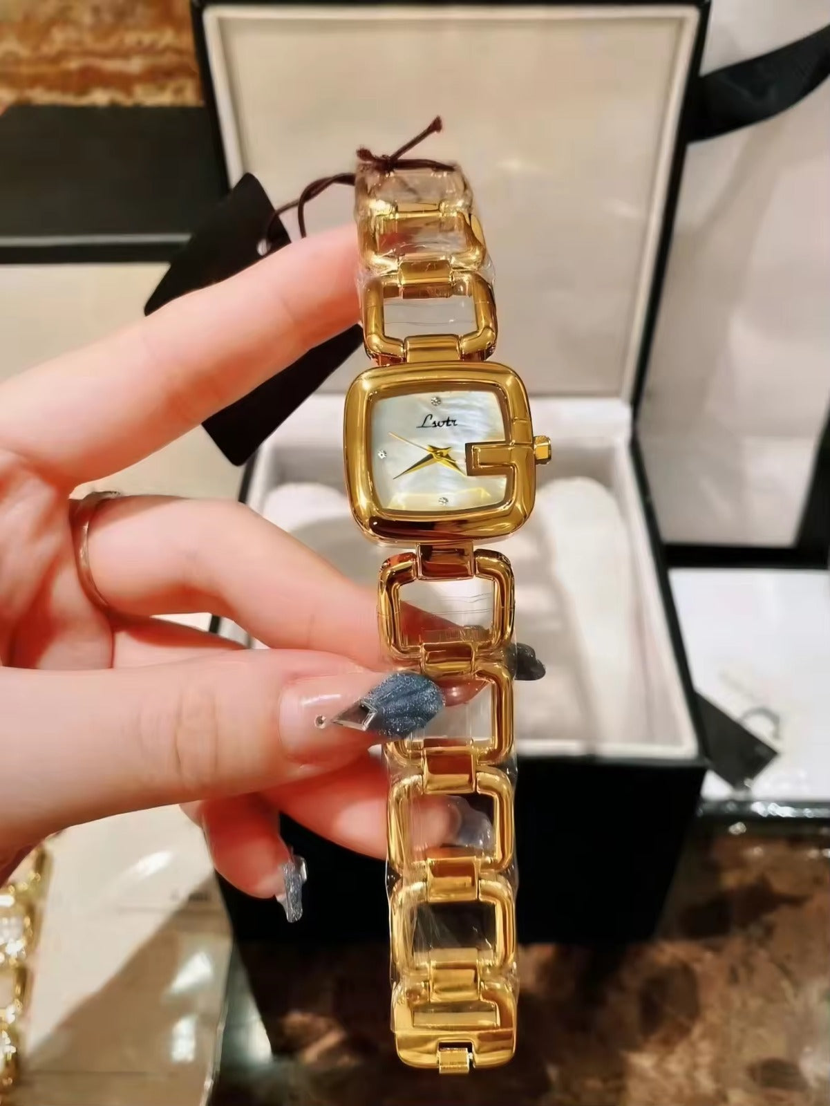 Women’s silver cushion square watch with black mother of pearl dial and open
square-link bracelet — Le Belle Heure